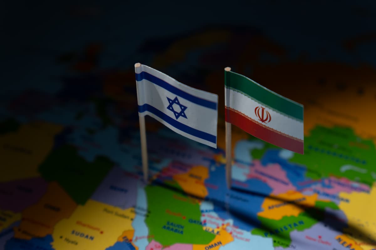 miniature-flags-israel-iran-are-planted-blurred-map-international-relations-conflict-diplomacy-geographical-focus-middle-east-concept