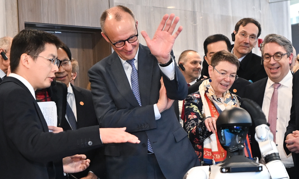 German Chancellor Friedrich Merz waves to a humanoid robot during his visit to the Chinese robot company Unitree Robotics in East China's Hangzhou on February 26, 2026. Photo: cnsphoto